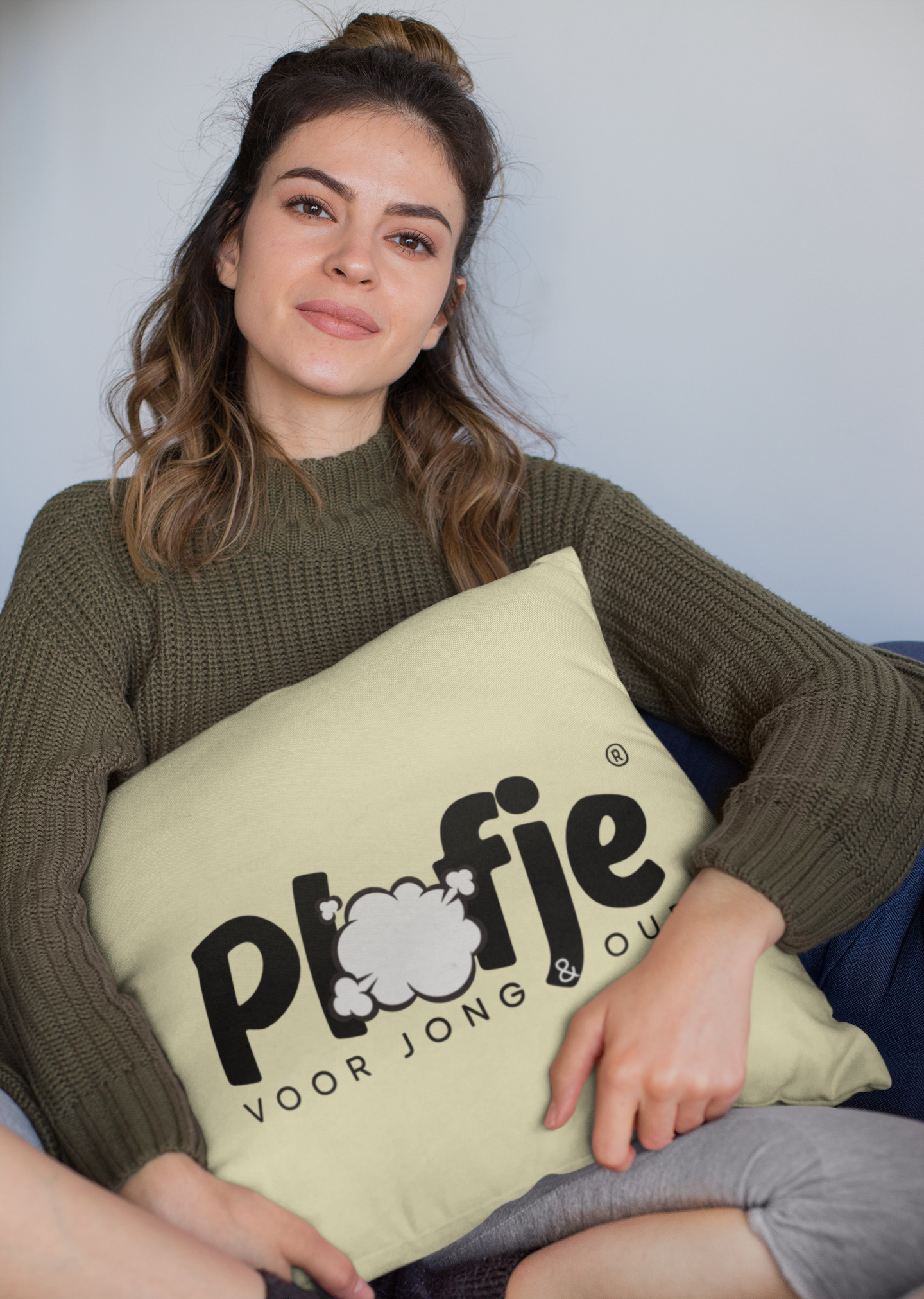 mockup-of-a-woman-holding-a-square-pillow-while-sitting-23577_0f427c5a-ec99-40a5-a890-386d6dd631ef.png